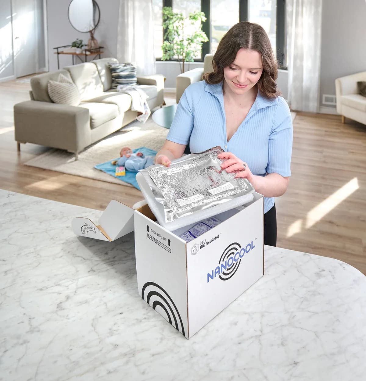 Patient packing a refrigerated specimen into a NanoCool shipper at a kitchen counter